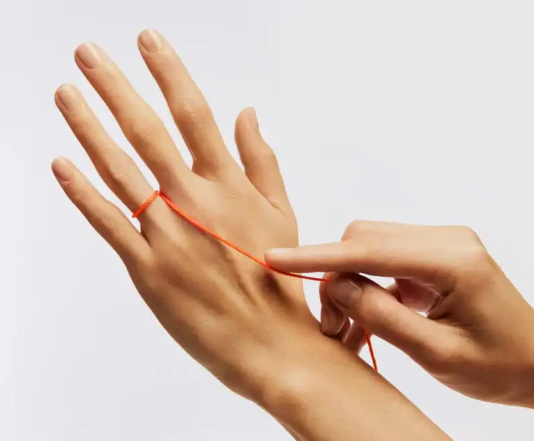 String wrapped around the base of a finger